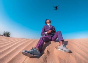Drone-style cinematic shot of a filmmaker using OBSBOT camera in the Middle East